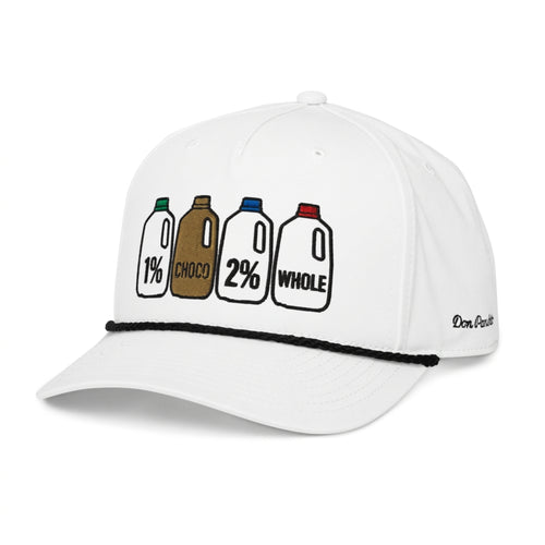 A white baseball cap featuring a graphic of four milk bottles labeled 1% CHOCO, 2%, and WHOLE on the front panel, with a black braided trim across the brim and 'DON PANCHITO' embroidered on the side.