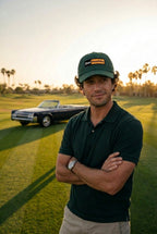 A man stands on a golf course at sunset wearing a dark green polo shirt, khaki pants, and the green DON PANCHITO LATENIGHT dad hat. A dark convertible car is parked in the background.